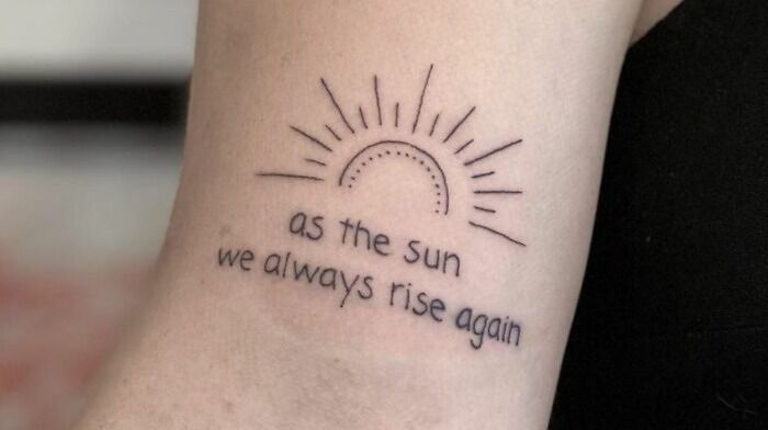 as the sun we always rise again quote arm tattoo