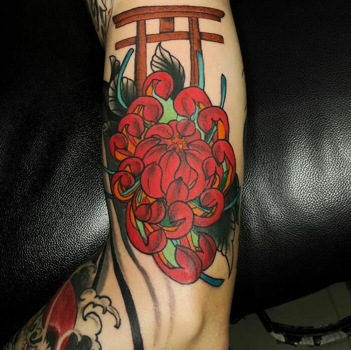 Red flower tattoo