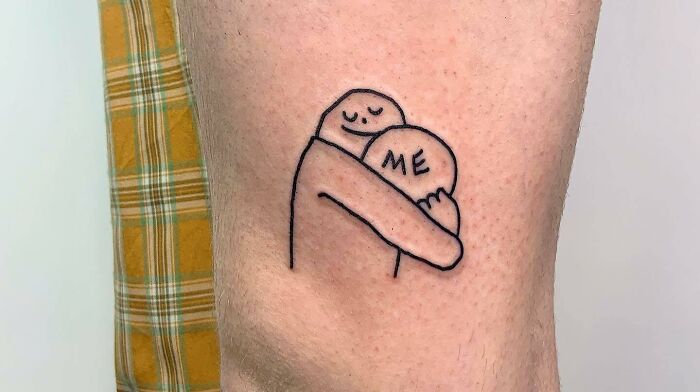 Hug himself arm tattoo