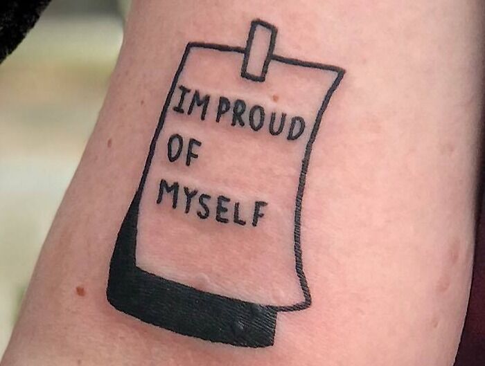 Self-love tattoo reading "I'm proud of myself" on skin.
