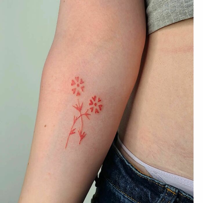 Minimalistic flower tattoo on forearm radiates elegance and beauty.