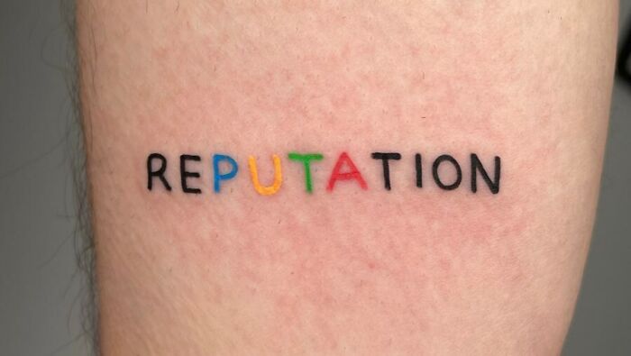 Reputation word arm tattoo