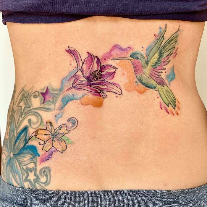 Watercolor flower and bird tattoo