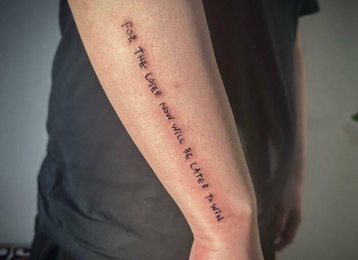Self-love tattoo with inspiring text on a person's forearm, symbolizing positivity and resilience.
