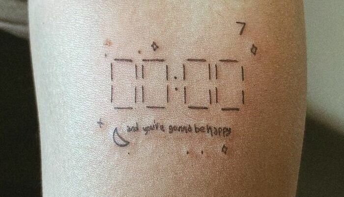 Digital clock self-love tattoo on skin with stars and moon design.