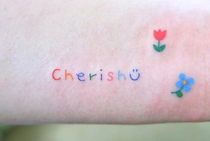 colorful cherish quote arm tattoo