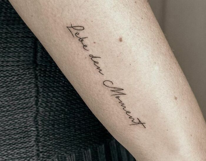 Live the moment quote arm tattoo