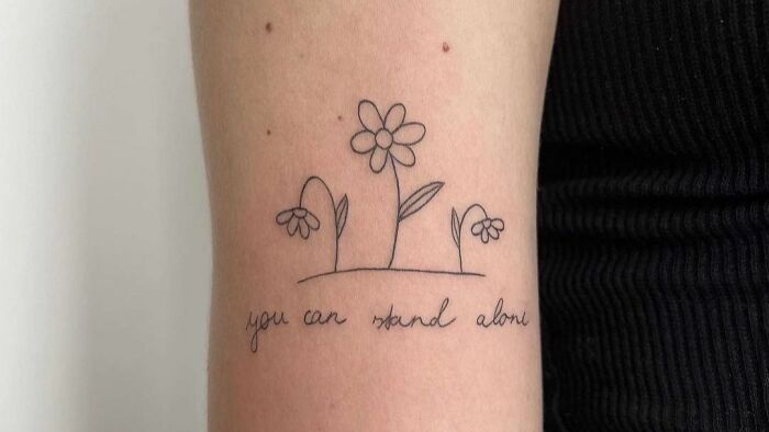 you can stand alone with line flowers arm tattoo