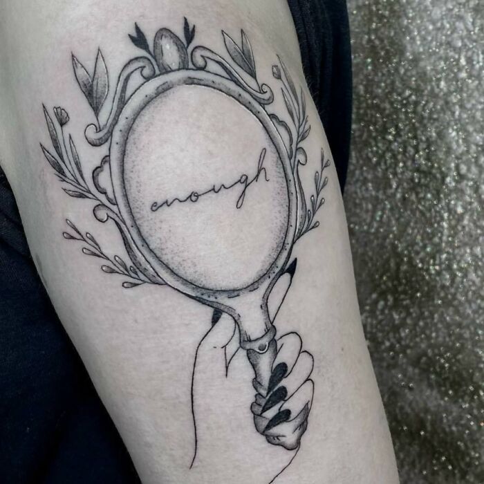 Hand holding mirror arm tattoo