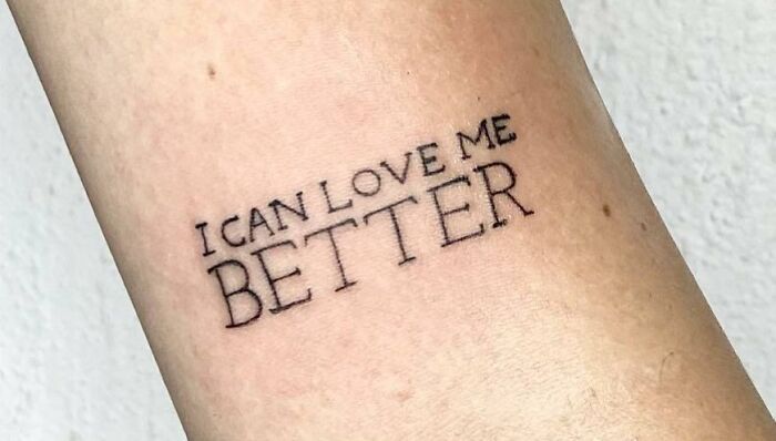 Self-love tattoo on an arm reading "I can love me better," emphasizing empowerment and personal growth.