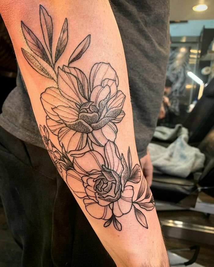Floral tattoo on forearm showcasing elegant and beautiful flower design.