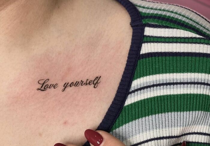 Love yourself chest quote tattoo