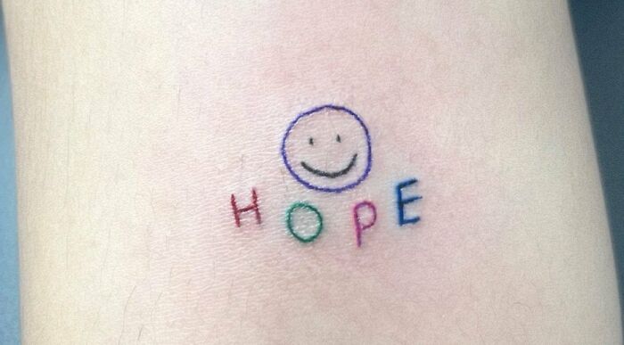 colorful letter hope with smile face arm tattoo