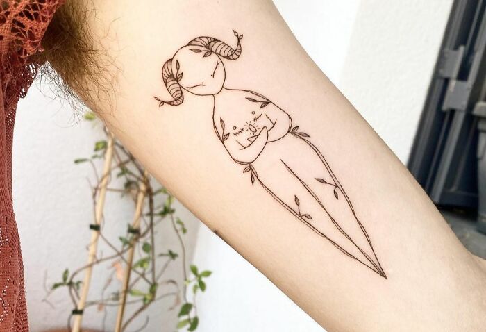 Person holding himself arm tattoo