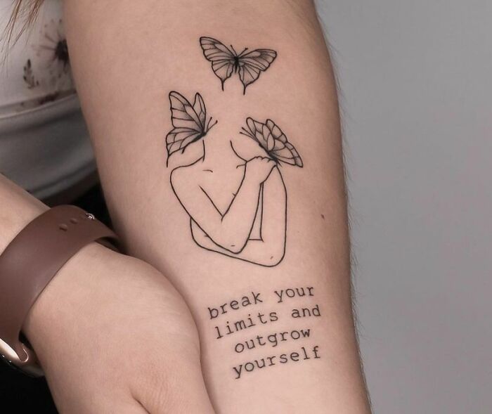 Line person hugging himself with butterflies and quote arm tattoo