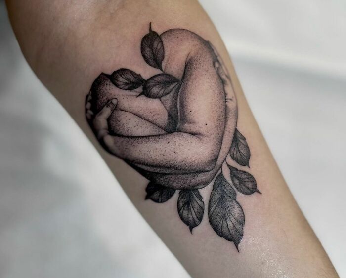 self hug with leaves arm tattoo