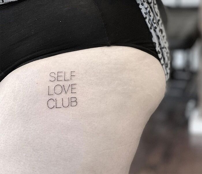 Self love club words leg tattoo