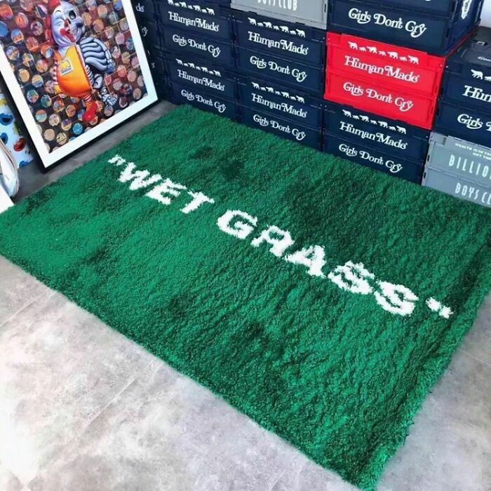 Wet grass word on a green rug