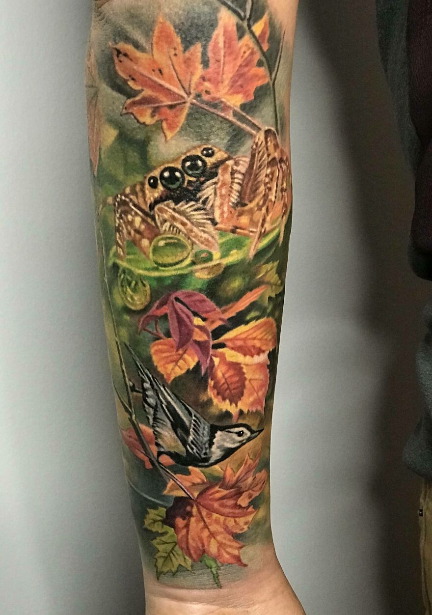 Colorful jumper and a nuthatch with autumn leaves tattoo on arm