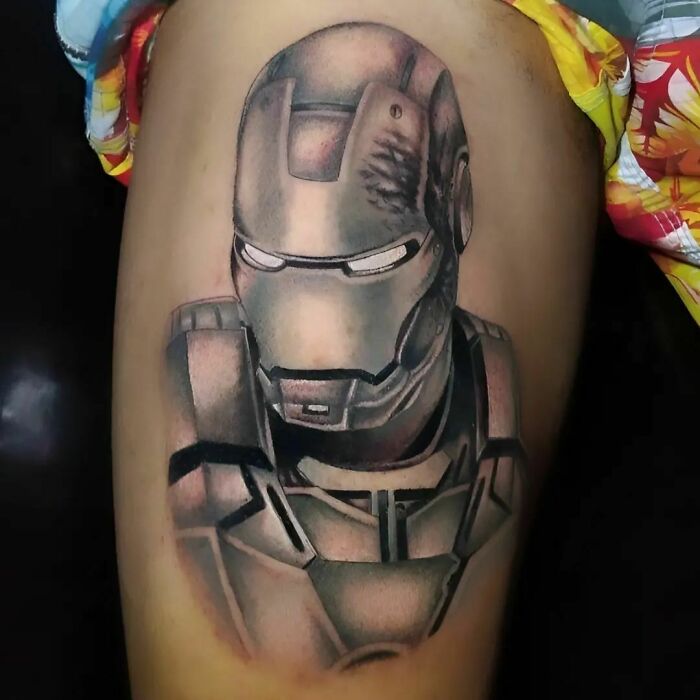 Iron Man tattoo on thigh, showcasing detailed Marvel superhero artwork in black and gray tones.