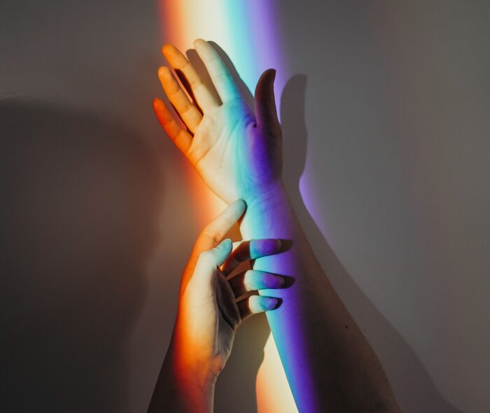 the colors of rainbow on the hands