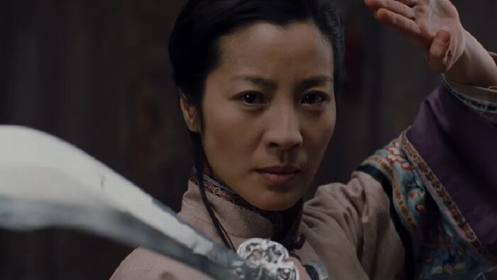 Jen Yu holding a sword 