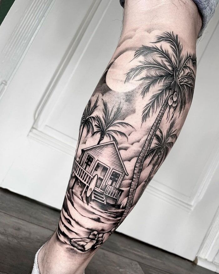 Calf tattoo featuring a tropical beach scene with palm trees and a house under the moonlight.