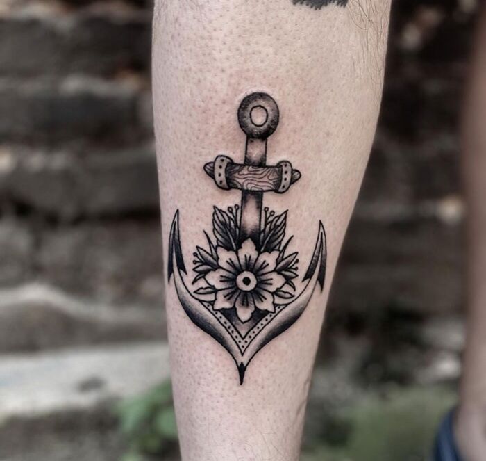 Anchor and flower calf tattoo design showcasing unique style and cool artistry.