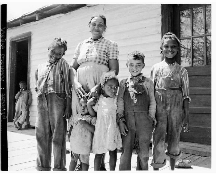 The Wife Of A Pitt County, North Carolina Tenant Farmer Standing On Her Porch With Six Children In 1949