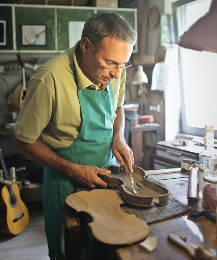 Man Repairing The Violin 