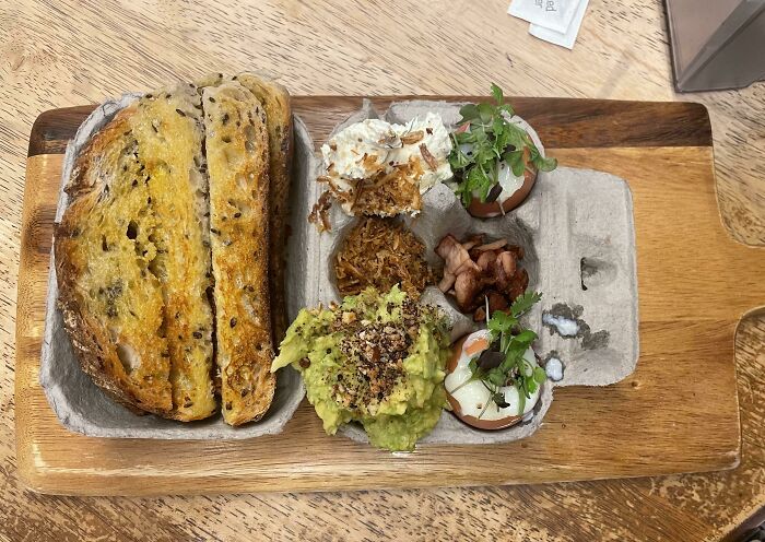 Breakfast Served In A Cardboard Egg Carton On A Chopping Board. Yummy, But Difficult To Eat