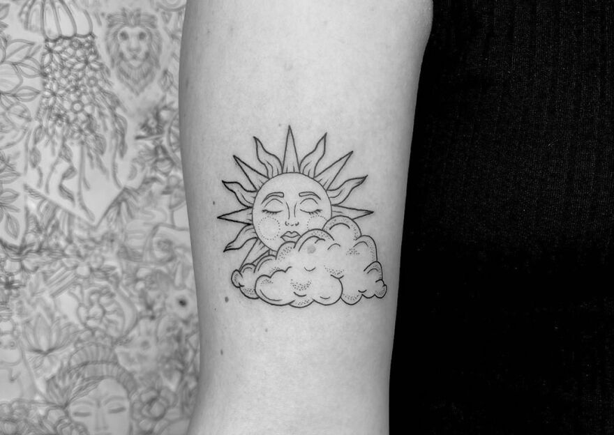 Sun and cloud arm tattoo