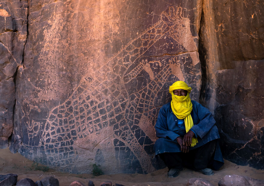 Tuareg Near A Rock Carving Depicting Giraffes, Tassili N'ajjer National Park, Tadrart Rouge, Algeria