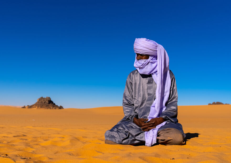 Tuareg Sits In The Sahara Desert, North Africa, Erg Admer, Algeria