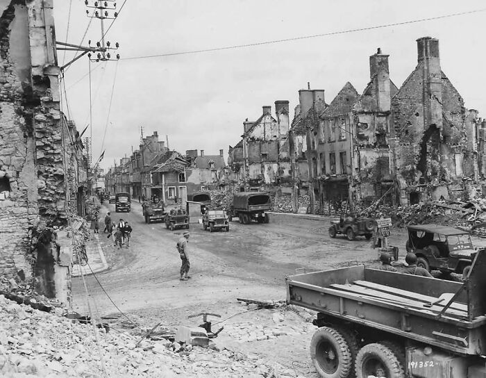 Pictured Above Are American Trucks And Jeeps Belonging To The 1st Army In The Town Of Isigny, France During 1944