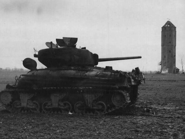 Pictured Above Is An American M4 Sherman That Has Been Knocked Out By A German 88mm Shell Near Blatzheim, Germany