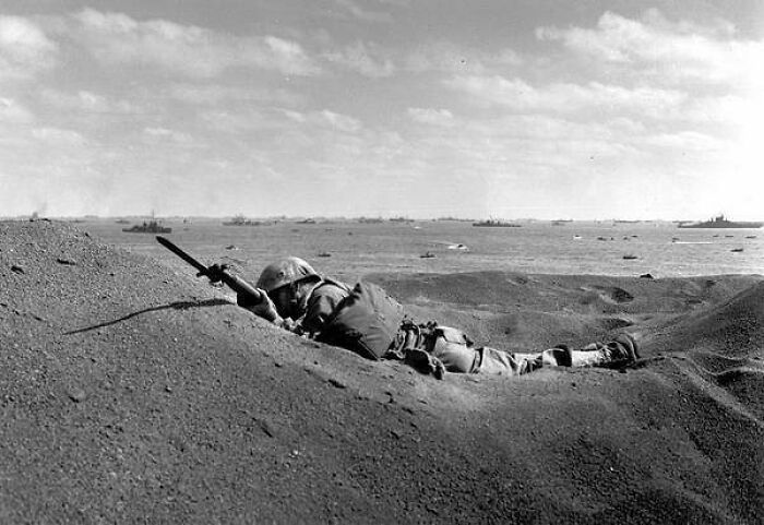 Pictured Above Is A U.S. Marine Killed By Japanese Sniper Fire, Still Holding His Weapon As He Lies In The Black Volcanic Sand Of Iwo Jima 