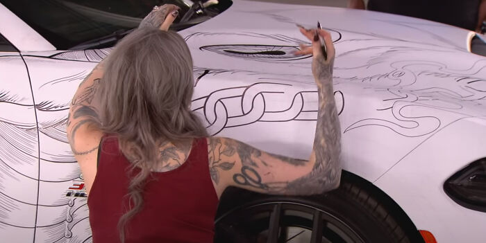 Woman drawing on the car 