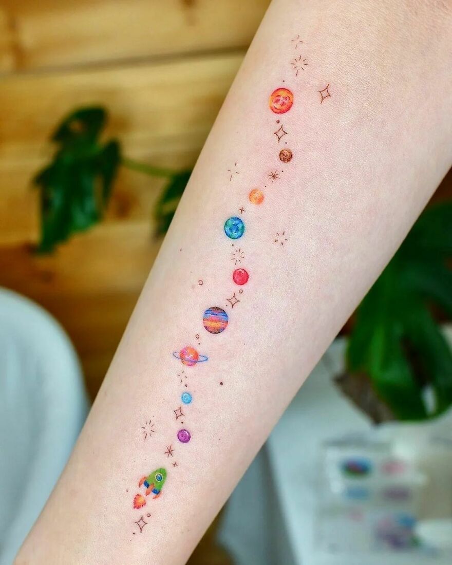 Tiny planets and rocket arm tattoo
