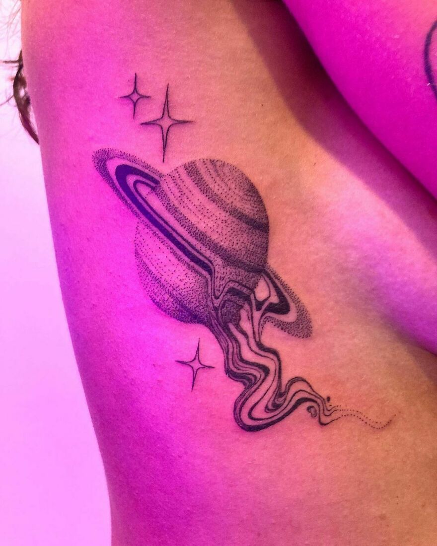 Saturn tattoo on ribs