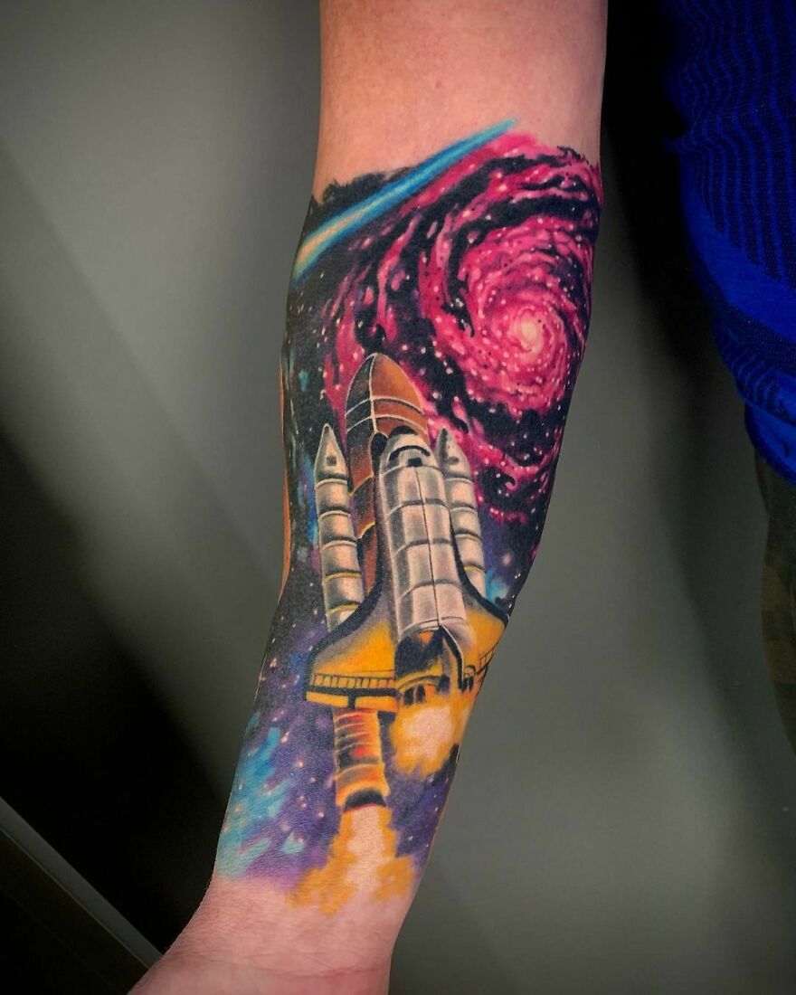 Space rocket forearm tattoo