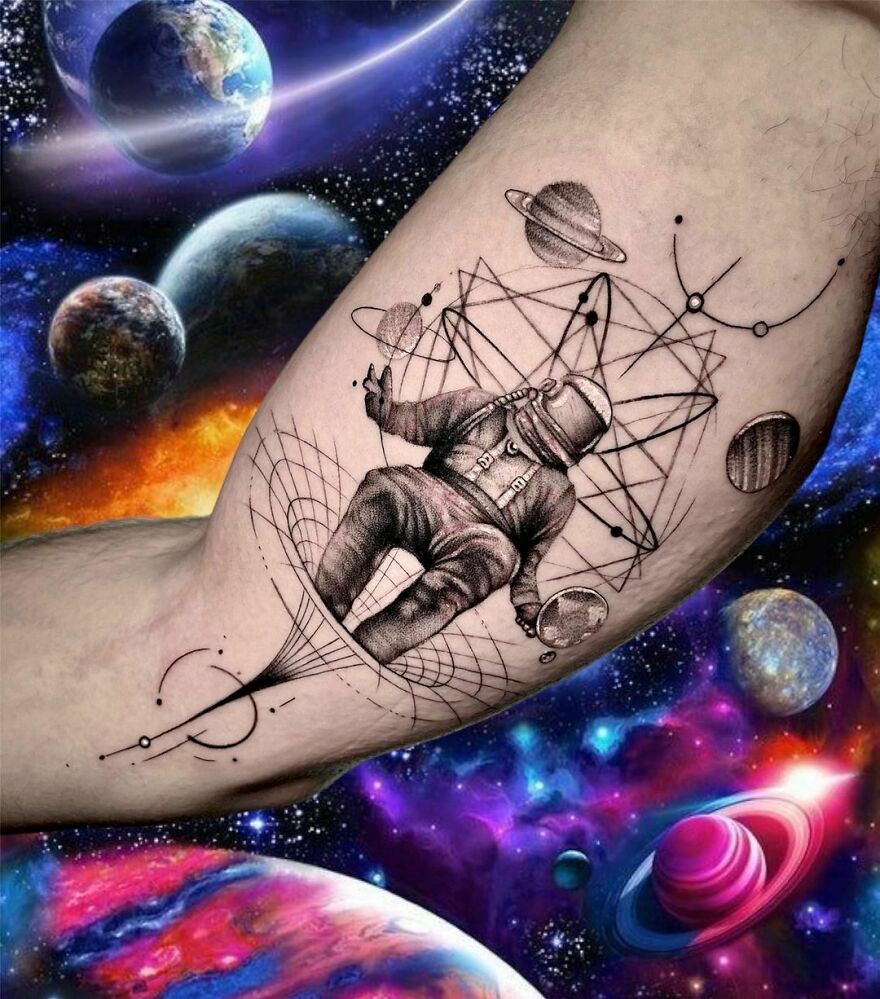 Astronaut with planets floating around arm tattoo