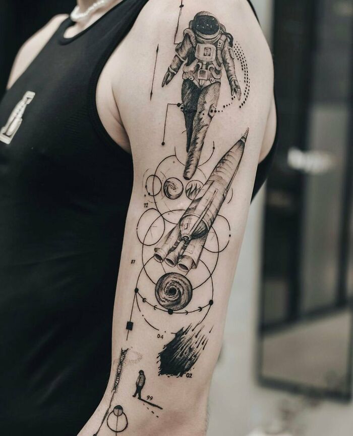 Astronaut and rocket arm tattoo
