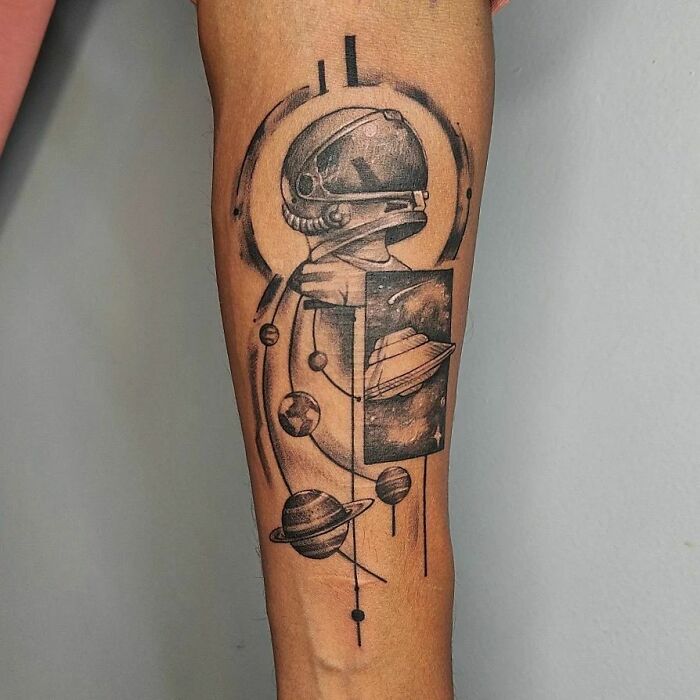 Astronaut and space arm tattoo