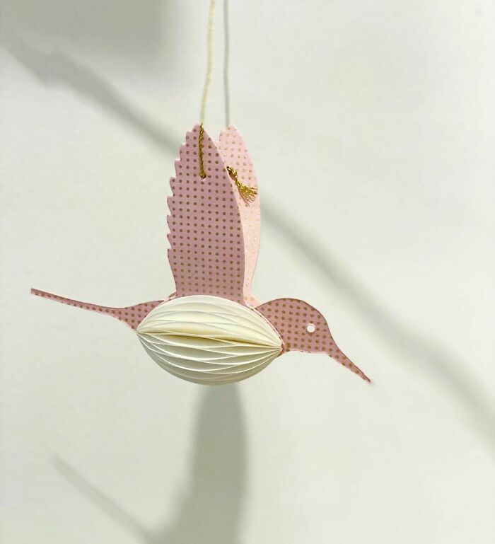 a white and pink paper hummingbird
