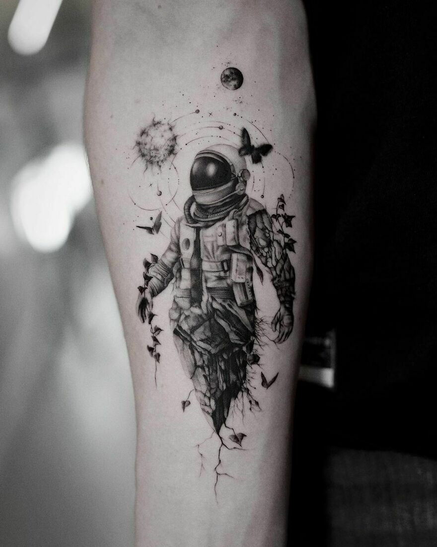 Astronaut arm tattoo