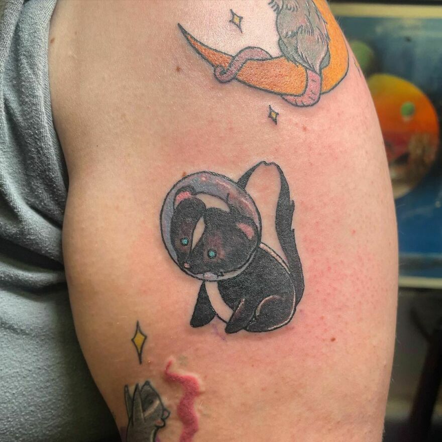 Little cute space skunk arm tattoo