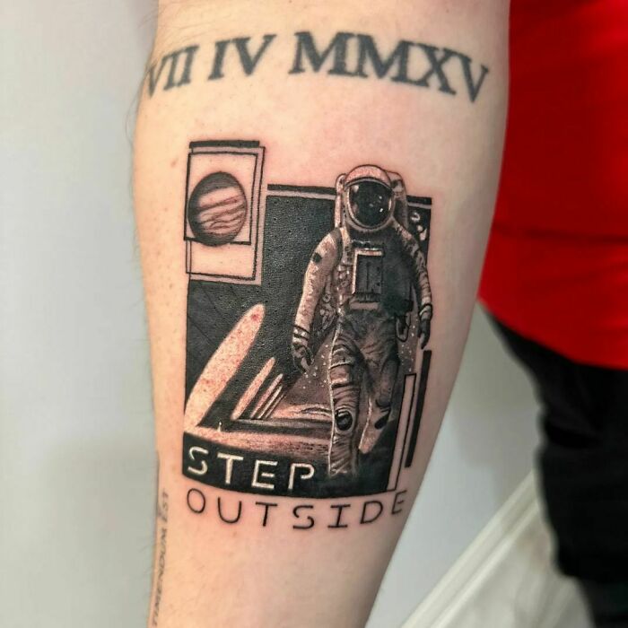 Astronaut arm tattoo