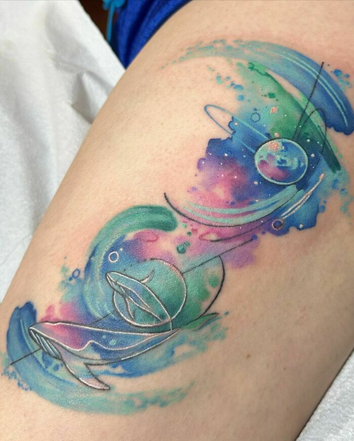 Watercolor space whales tattoo