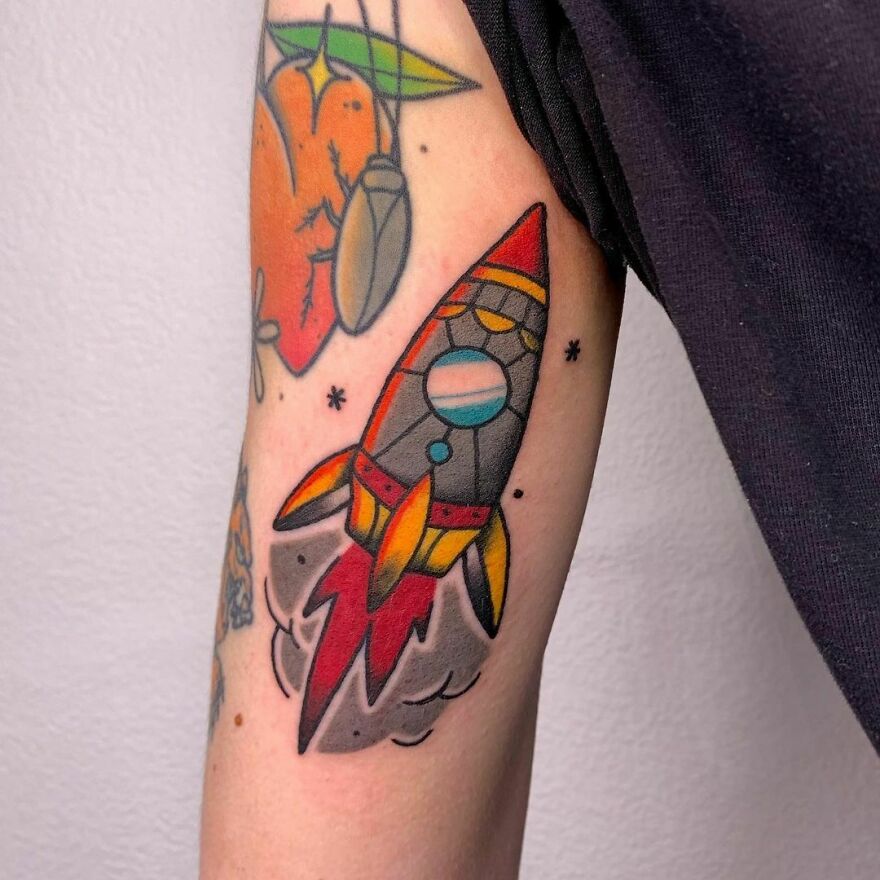 Colorful rocket arm tattoo